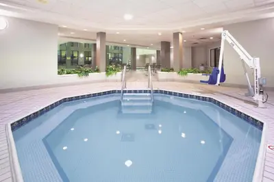 a large swimming pool in a hotel lobby at La Quinta by Wyndham Denver Englewood Tech Ctr in Greenwood Village