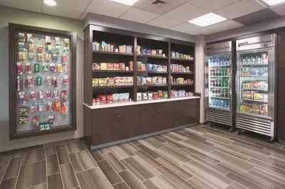 a grocery store aisle with two refrigerators and drinks at La Quinta by Wyndham Denver Englewood Tech Ctr in Greenwood Village