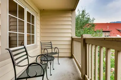 two chairs and a table on a balcony at 1 Bedroom Colorado Vacation Rental In River Run Village Steps From The River Run Gondola in Keystone