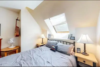 a bedroom with a bed with blue sheets and a window at 1 Bedroom Silvermill Rental In River Run Village Steps From The River Run Gondola in Dillon