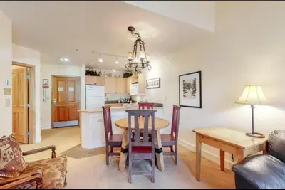 a dining room and kitchen with a table and chairs at 1 Bedroom Silvermill Rental In River Run Village Steps From The River Run Gondola in Dillon
