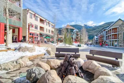 a group of benches and rocks in a town at 1 Bedroom Silvermill Rental In River Run Village Steps From The River Run Gondola in Dillon