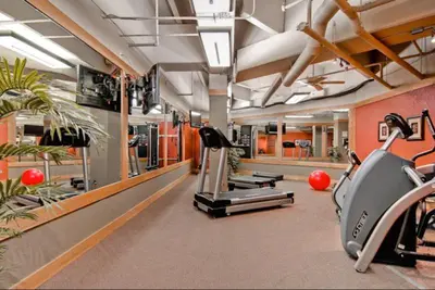 a gym with treadmills and elliptical machines at 1 Bedroom Silvermill Rental In River Run Village Steps From The River Run Gondola in Dillon
