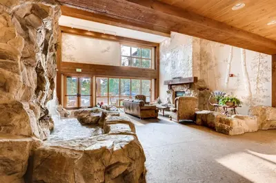 a large room with a large stone wall at 1 Bedroom Springs Condo In River Run Village Just 75 Yards From The River Run Gondola in Dillon
