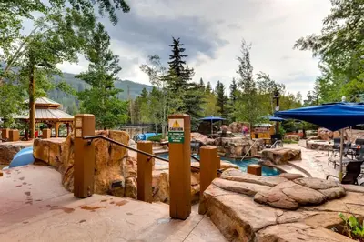 a water park with a slide and a pool at 1 Bedroom Springs Condo In River Run Village Just 75 Yards From The River Run Gondola in Dillon