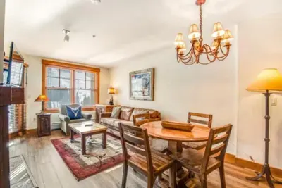 a living room with a table and a couch at 1 Bedroom Springs Condo In River Run Village Just 75 Yards From The River Run Gondola in Dillon