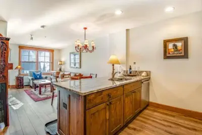 a kitchen with a large island in a living room at 1 Bedroom Springs Condo In River Run Village Just 75 Yards From The River Run Gondola in Dillon