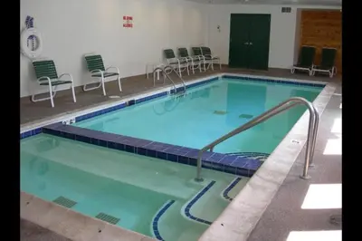 a large swimming pool with chairs in a building at Studio Colorado Vacation Rental Located Near River Run Village With Hot Tub And Pool Access in Keystone