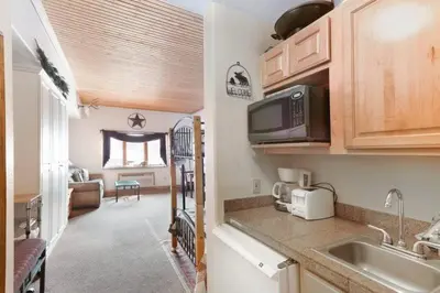 a kitchen with a sink and a living room at Studio Colorado Vacation Rental Located Near River Run Village With Hot Tub And Pool Access in Keystone