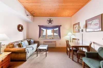 a living room with a couch and a table at Studio Colorado Vacation Rental Located Near River Run Village With Hot Tub And Pool Access in Keystone