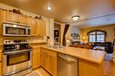 a kitchen with a sink and a stove top oven at 2 Bedroom Colorado Vacation Rental In River Run Village With Pool And Hot Tub Access in Keystone