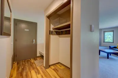 a hallway with a door leading to a living room at Frostfire E41 Condo in Keystone