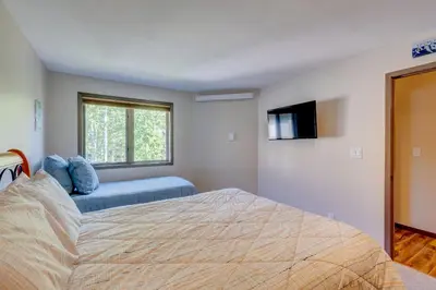 a bedroom with a bed and a flat screen tv at Frostfire E41 Condo in Keystone