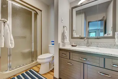 a bathroom with a shower and a toilet and a sink at Frostfire E41 Condo in Keystone