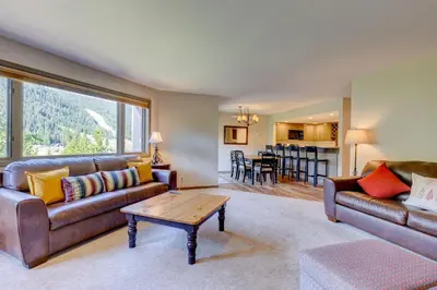 a living room with a couch and a table at Frostfire E41 Condo in Keystone