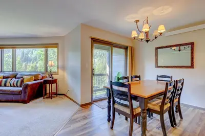 a dining room with a table and a couch at Frostfire E41 Condo in Keystone