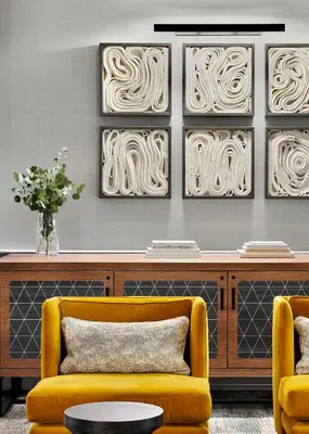 a living room with a yellow couch and two chairs at Kimpton Hotel Monaco Denver by IHG in Denver