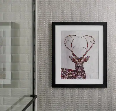a framed picture of a deer with a heart at Kimpton Hotel Monaco Denver by IHG in Denver