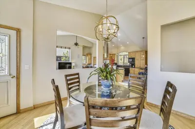 a dining room and kitchen with a table and chairs at Larson Lane 217 Home in Frisco