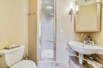 a bathroom with a shower and a toilet and a sink at Larson Lane 217 Home in Frisco