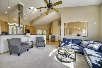 a living room with a blue couch and chairs at Larson Lane 217 Home in Frisco