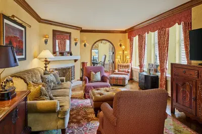 a living room with a couch and chairs and a fireplace at The Brown Palace Hotel and Spa, Autograph Collection in Denver