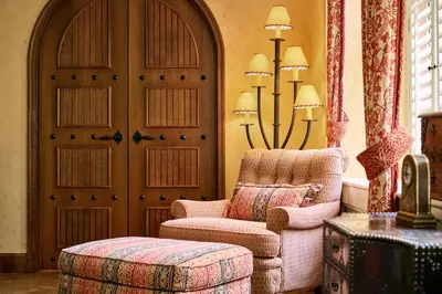 a living room with a chair and a door at The Brown Palace Hotel and Spa, Autograph Collection in Denver