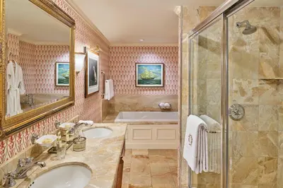 a bathroom with two sinks and a shower at The Brown Palace Hotel and Spa, Autograph Collection in Denver