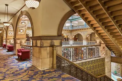 a hallway with a staircase in a building at The Brown Palace Hotel and Spa, Autograph Collection in Denver
