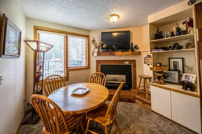 a dining room with a table and a fireplace at Iron Horse Building C Unit 1023 in Winter Park