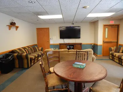 a waiting room with couches and a table and a tv at Iron Horse Building D Unit 4104 in Winter Park
