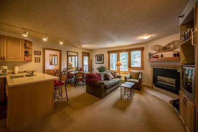 a kitchen and living room with a couch and a fireplace at Iron Horse Building D Unit 4104 in Winter Park