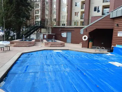 a large blue swimming pool in front of a building at Iron Horse Building D Unit 4104 in Winter Park