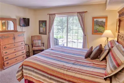 a bedroom with a large bed and a window at Villas at Swan's Nest #701 (Condo) in Gold Hill