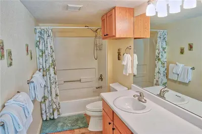 a bathroom with a sink and a toilet and a shower at Villas at Swan's Nest #701 (Condo) in Gold Hill