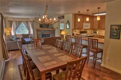 a dining room and kitchen with a table and chairs at Villas at Swan's Nest #701 (Condo) in Gold Hill