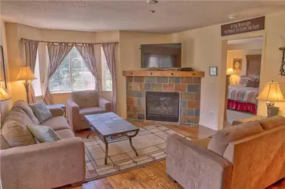 a living room with two couches and a fireplace at Villas at Swan's Nest #701 (Condo) in Gold Hill