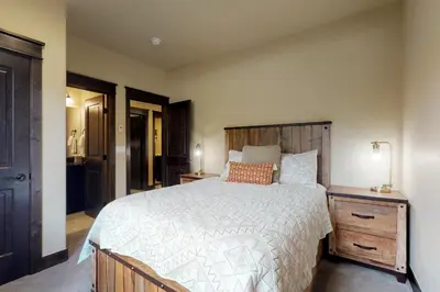 a bedroom with a large bed with a wooden headboard at Ogren Overlook in Keystone