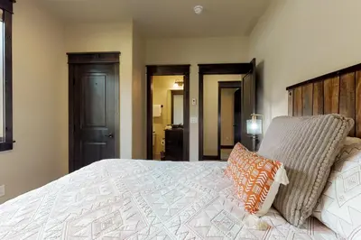 a bedroom with a large bed with two pillows on it at Ogren Overlook in Keystone