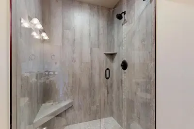 a shower with a glass door in a bathroom at Ogren Overlook in Keystone