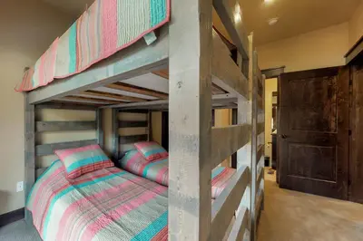 a bedroom with two bunk beds in a room at Ogren Overlook in Keystone