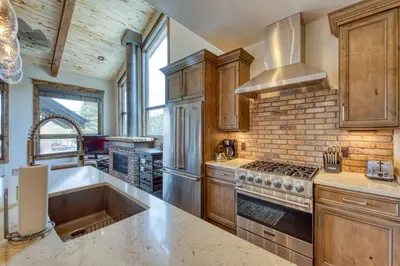 a kitchen with a sink and a stove at 2nd Ave Luxury in Frisco