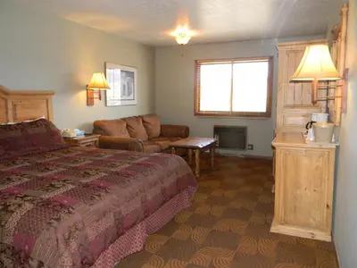 a hotel room with a bed and a couch at New Summit Inn in Frisco