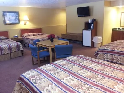 a hotel room with two beds and a table at New Summit Inn in Frisco