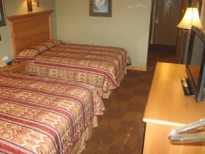 a hotel room with two beds and a table at New Summit Inn in Frisco