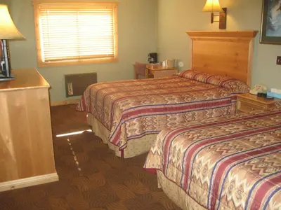 a hotel room with two beds and a window at New Summit Inn in Frisco