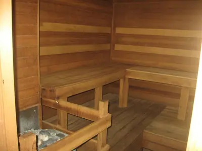 a wooden sauna with wooden benches in a room at New Summit Inn in Frisco