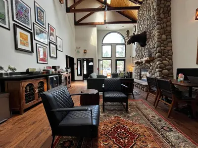 a living room with chairs and a stone fireplace at Hotel Frisco in Frisco