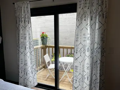 a room with a balcony with curtains and a table at Hotel Frisco in Frisco