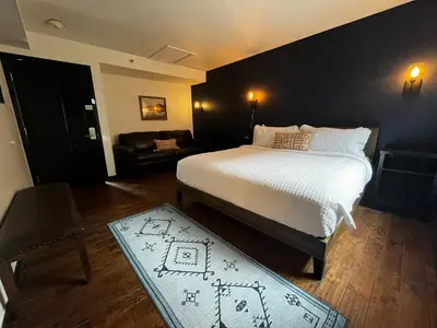 a bedroom with a large bed and a couch at Hotel Frisco in Frisco